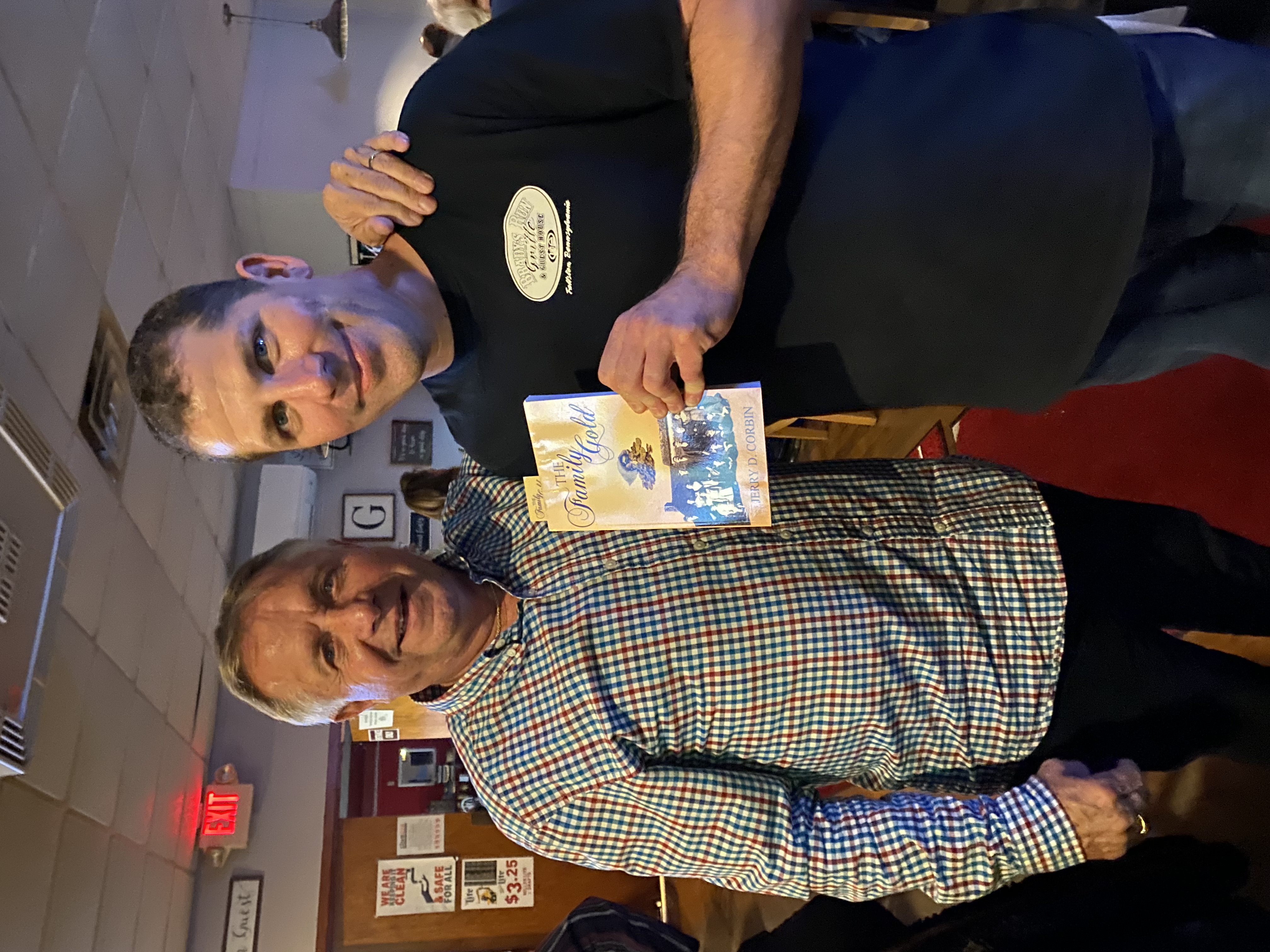 Reader with The Family Gold at a restaurant